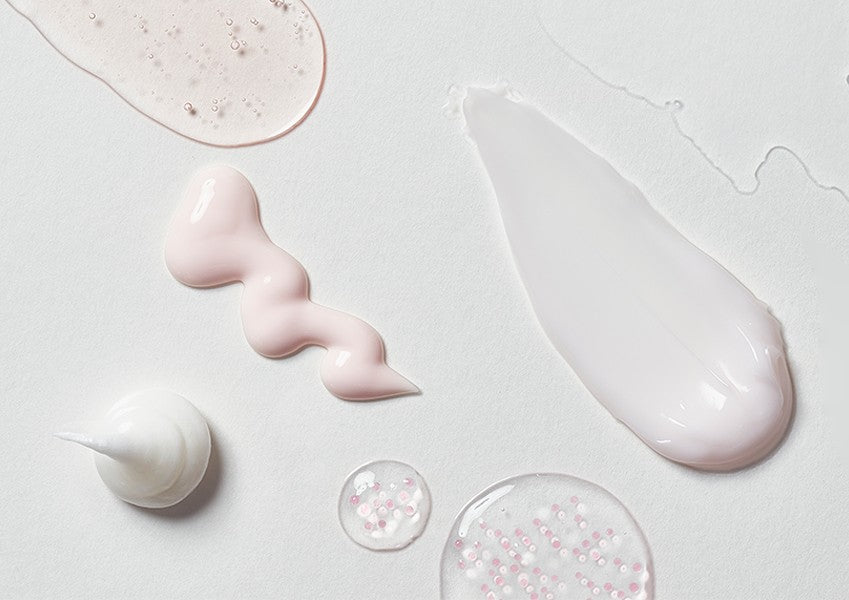 Swatches of KAHI Wrinkle Bounce skincare textures on a pale surface