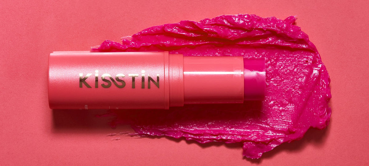 KAHI Kisstin Balm stick on a swatch of its pink tinted balm