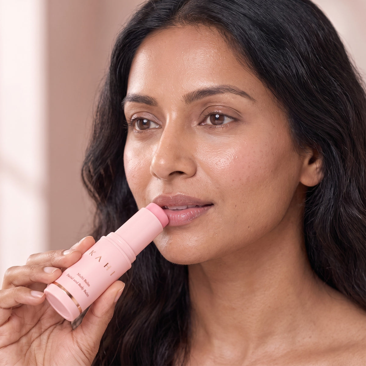 Woman gliding the KAHI Multi Balm across her lips