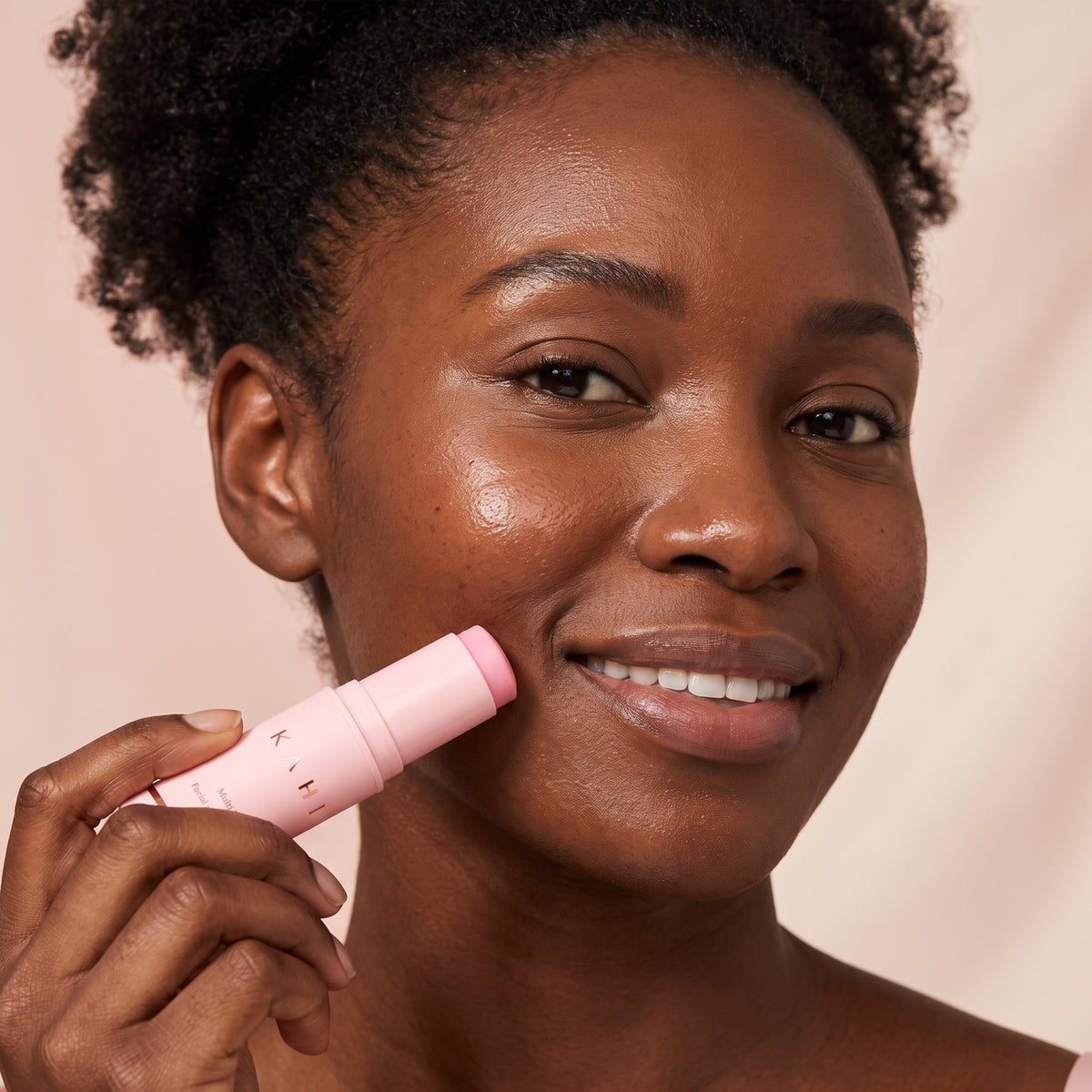 Woman gliding the KAHI Multi Balm along her smile line