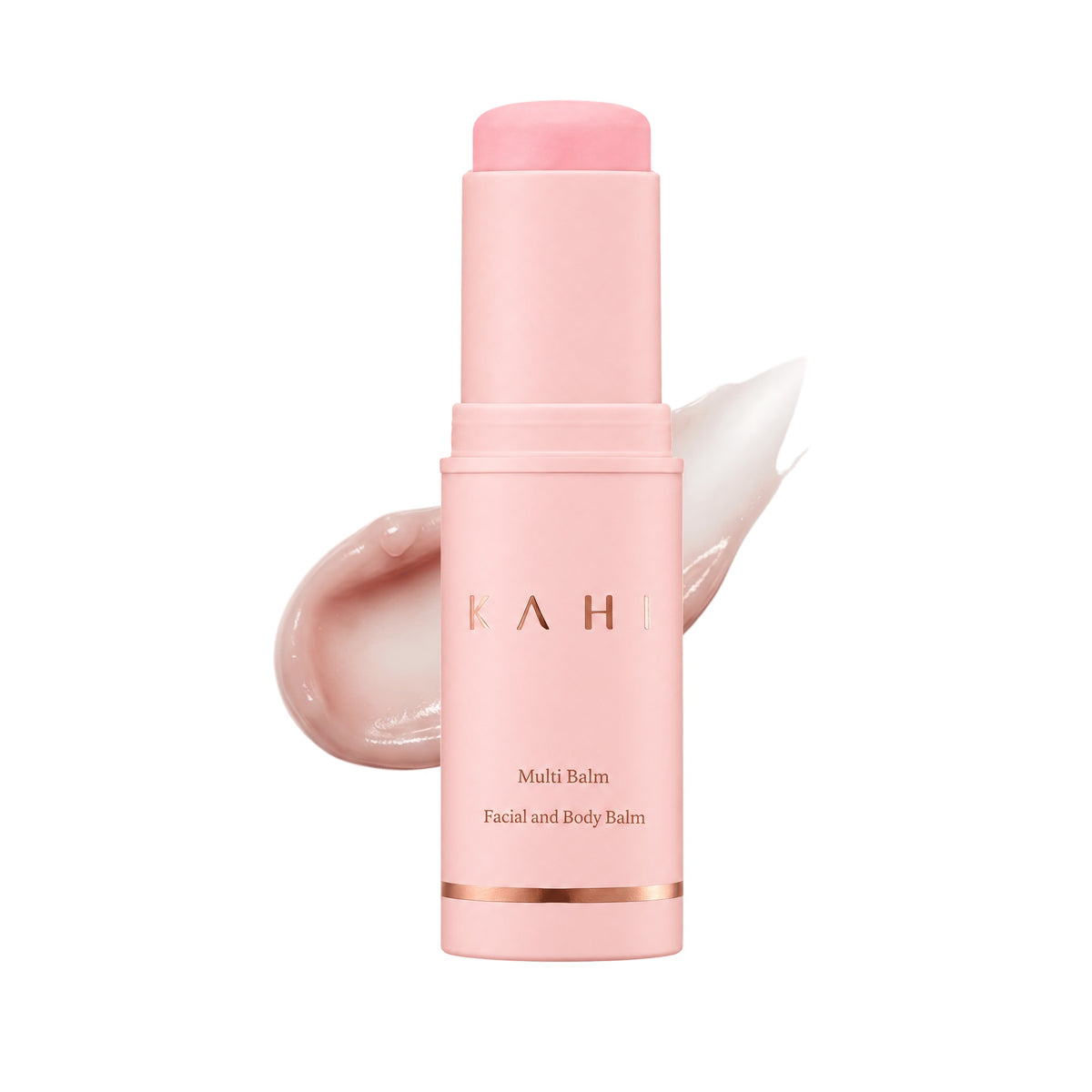 KAHI Multi Balm stick in front of a swipe of its pink balm