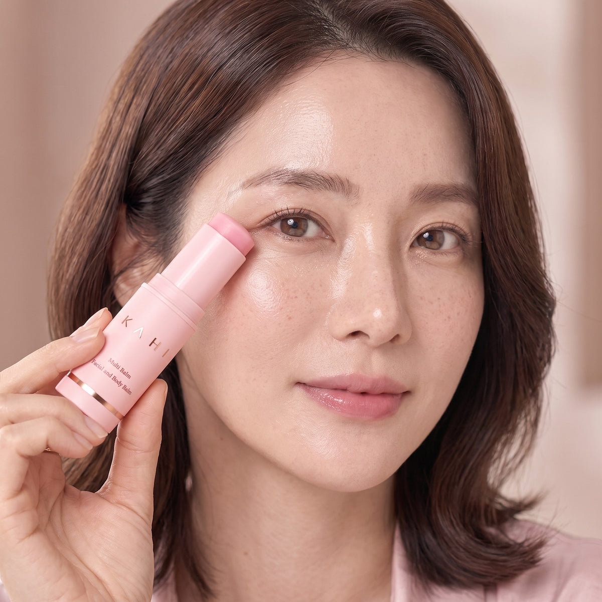 Woman gliding the KAHI Multi Balm under her eye